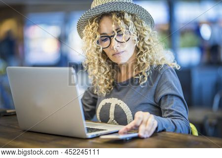 Young Adult Modern Woman Work At The Store Table With Laptop Computer And Mobile Phone In Roaming Co