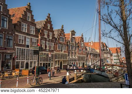 Hoorn, Netherlands, March 2022. The Harbor Of Hoorn With The Old Boats And Historic Facades.
