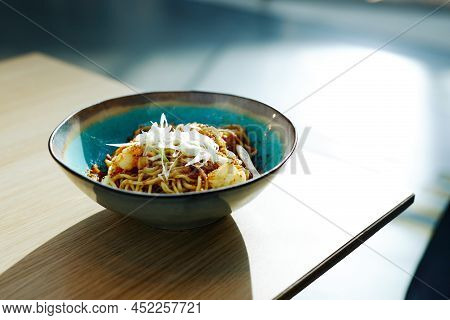 Minimal Close Up Of Homemade Asian Food Dish In Vibrant Blue Bowl Lit By Sunlight, Copy Space