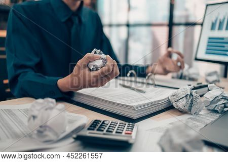 Serious Investors Have A Mad Crump Paper And Angry While Working  On The Desk.  Accounting And  Fina