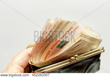 Russian Rubles Bills In Open Wallet. The Denomination Of The Banknotes Is Five 5000 Thousand Rubles.