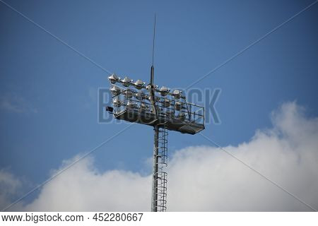 Football Spotlights For Lighting The Field For The Game. Gray Pole With Lanterns