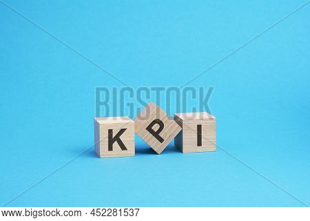 Kpi Text On Wooden Blocks, Business Concept, Blue Background