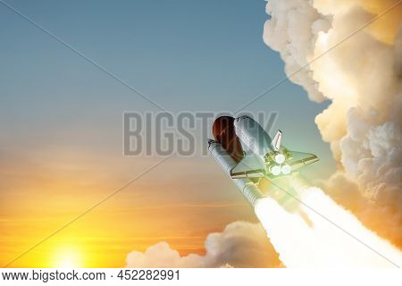 Spaceship Lift Off. Space Shuttle With Smoke And Blast Takes Off Into Space On A Background Of Sunse