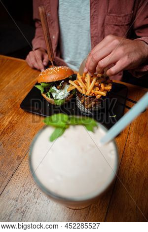 Friends Eating Buger And Milkshake At The Restaraunt