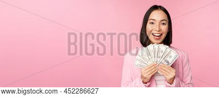 Finance, Microcredit And People Concept. Happy Smiling Asian Businesswoman Showing Dollars Money, St