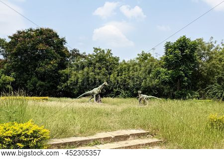 Beautiful Long Shot Of Dinosaurs Cement Sculptures Isolated In Gulbarga University Garden: Kalaburag