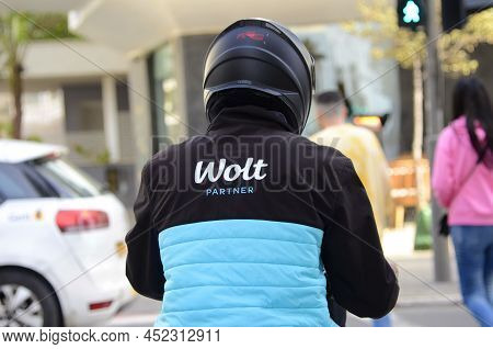 17.03.2022 Tel Aviv. Israel - Food Delivery Wolt. Delivery Courier - Back At Crosswalk. Close-up Bra