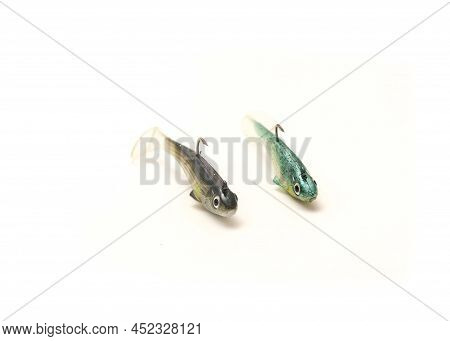 Two Jig Head Shad Soft Fishing Lures With Hook And Paddle Tail Swimbaits Isolated On White Backgroun