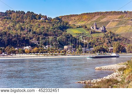 Castle Stahleck. Medieval knight's castles and ruins. Warm autumn in Germany. Beautiful wooded slopes of the coastal hills of the river Rhine. 