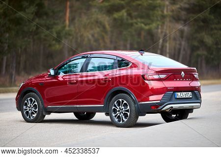 Berlin - March 2022: 2021 Renault Arkana E-tech Hybrid Suv Car Three Fourth Left Side Back View Outd