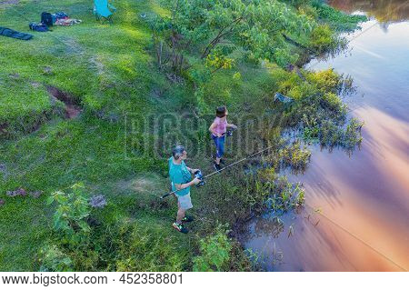 Aerial View Of A Man And Woman Fishing On The Tebicuary River In Paraguay.