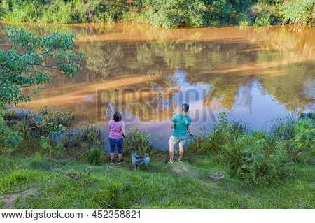 Aerial View Of A Man And Woman Fishing On The Tebicuary River In Paraguay.
