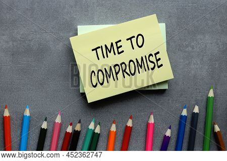 Time To Compromise Text On Yellow Sticker On Gray Background
