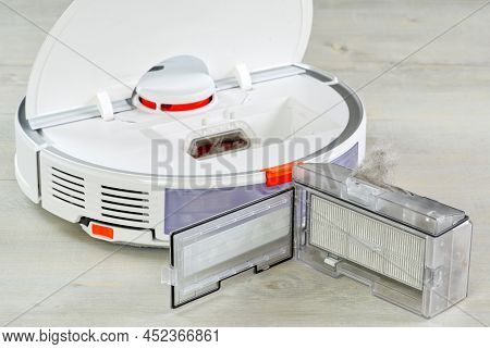 Robot Vacuum Cleaner Water Tank Removed And The Filter Lid Is Opened To Clean. Smart Cleaning And Wa
