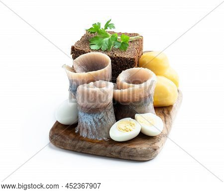 Homemade  Marinated Herring Roll With Rye Bread And Baby Potato With Quial Eggs Isolated In White
