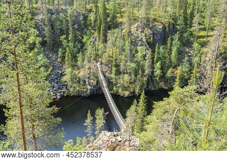 View To The Canyon Lake Julma-olkky And Wooden Bridge Over The Lake, Hossa National Park, Kuusamo, F