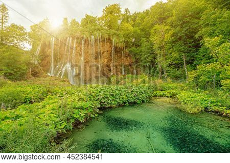 Sunshine On Veliki Prstavac Waterfall Reflected In The Potok Plitvice Lake Of Plitvice National Park