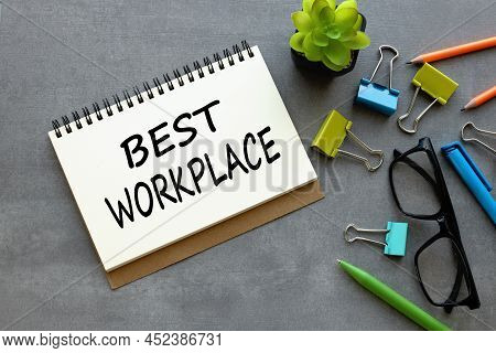 Best Workplase. Text On An Open Notebook Next To A Home Plant Of Green And Blue Stationery Clips