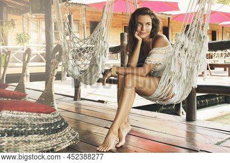 Young Beautiful Woman Sitting In The Hammock