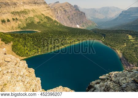 The Blue Of Pitamakan Lake From The Pass High Above In Glacier National Park