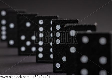 Black Dominoes On Dark Background, Closeup Scattered Dominoes On A Gray, Table. Board Game, Game Nig