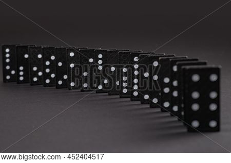 Black Dominoes On Dark Background, Closeup Scattered Dominoes On A Gray, Table. Board Game, Game Nig