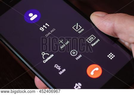 Dialing 911, Call 911. Emergency Concept: Man Using A Digital Phone With Emergency Call On The Scree