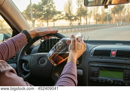 Man Drinking Alcohol While Driving In His Car.