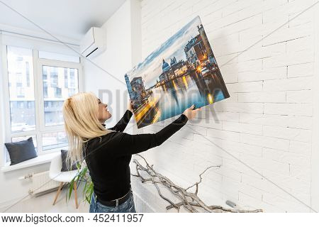 Photo Canvas Print. A Woman Holding A Photography With Gallery Wrap. Photo Printed On Glossy Synthet