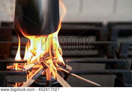 Saving Natural Gas In The Household. A Fragment Of A Jezva On The Kitchen Stove. Instead Of Gas, Fir