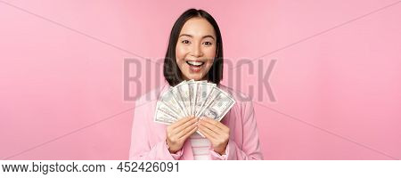 Finance, Microcredit And People Concept. Happy Smiling Asian Businesswoman Showing Dollars Money, St