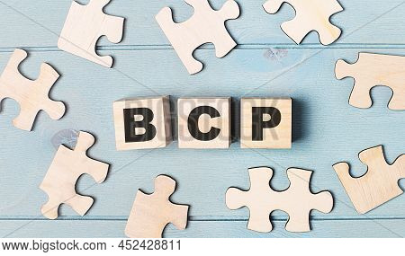 Blank Puzzles And Wooden Cubes With The Text Bcp Business Continuity Plan Lie On A Light Blue Backgr