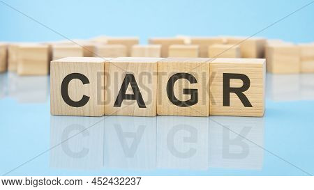 Letters Cagr Made With Wood Building Blocks. Blue Background. Business Concept
