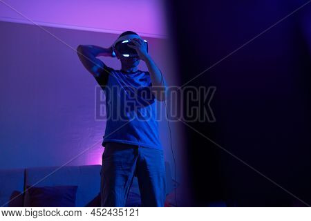Man With Virtual Reality Headset And Joystic Is Playing Game