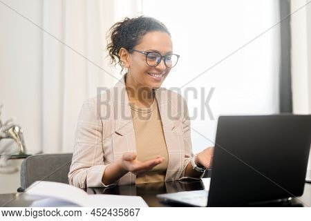 Video Meeting Concept. Cheerful Middle-aged Woman Holding Video Call On The Laptop At Office, Gestur