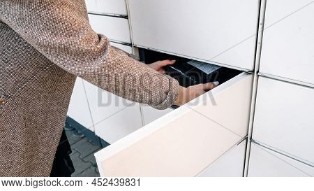 Pickup Parcel. Courier Box In Woman Hands At Post Delivery Automat Terminal. Self Service Post Termi