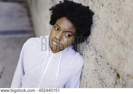 Portrait Of A Thoughtful Black Mixed Race African Female On Concreate Place