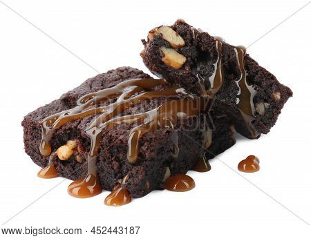 Delicious Chocolate Brownies With Nuts And Caramel Sauce On White Background