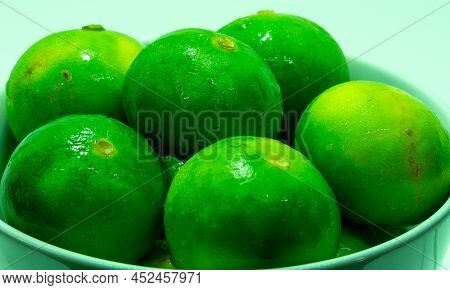 Fresh Wet Lemons (citrus Aurantiifolia) With Water Drops On Bowl