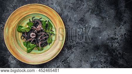 Squid Ink Spaghetti With Seafood Octopus, Mussels And Shrimps On Dark Background. Pasta Of Durum Whe