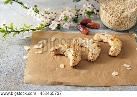 Healthy Festive Cookies From Almonds, Oat Flakes And Dates On Baking Paper, Ingredients And A Flower