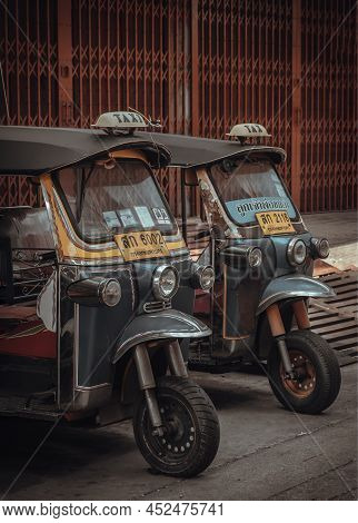 Bangkok, Thailand - Apr 06, 2022 : Famous Blue Tuk Tuk Or 3-wheeler Taxi. Side Of Two Thai Tradition