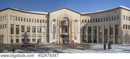 Rovaniemi, Finland - March 17th, 2022: Tourists In Front On The Rounded Facade Of The Arktikum Museu