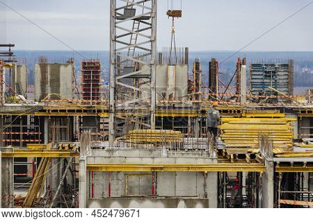 Monolithic Frame Construction Of The Building. Workers Working At The Construction Site At Home. The
