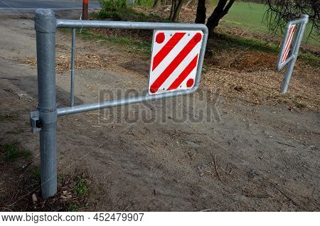 A Barrier To Dirt Road Consisting Of Two Barriers That Allow Cyclists And Pedestrians To Enter. Cars