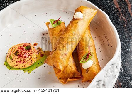 Deep fried popiah popia roll wraps with dipping sauce.