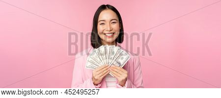 Finance, Microcredit And People Concept. Happy Smiling Asian Businesswoman Showing Dollars Money, St