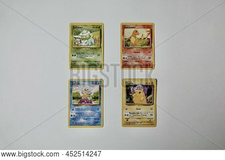 Prague, Czech Republic - April 3 2022: Bulbasaur, Charmander, Squirtle And Pikachu Pokemon Cards Fro