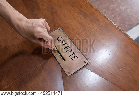 Hand Of Boy Who Puts Coin On The Box With Text Offerte That Means Offers In Italian Language In The 